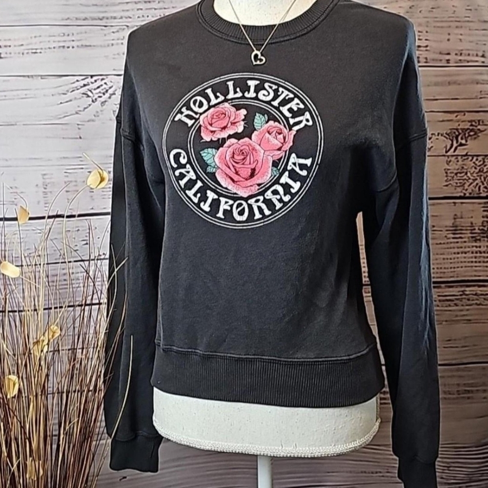 Hollister Black Sweatshirt with Pink Floral Design.